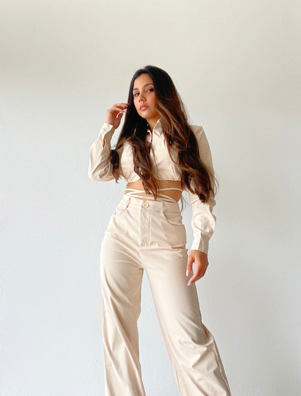 A fashion forward cropped blazer with criss cross tie detail and high waisted matching wide leg pants